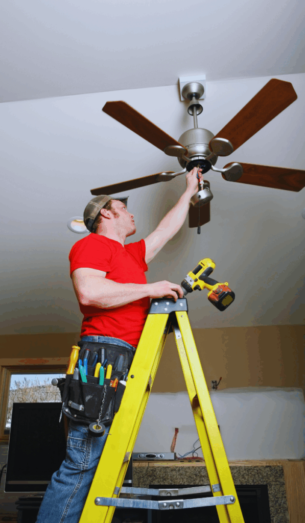 electrician fixing a ceiling fan electrical problem