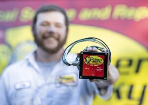 Mister Sparky Electrician holding a much needed surge protector 